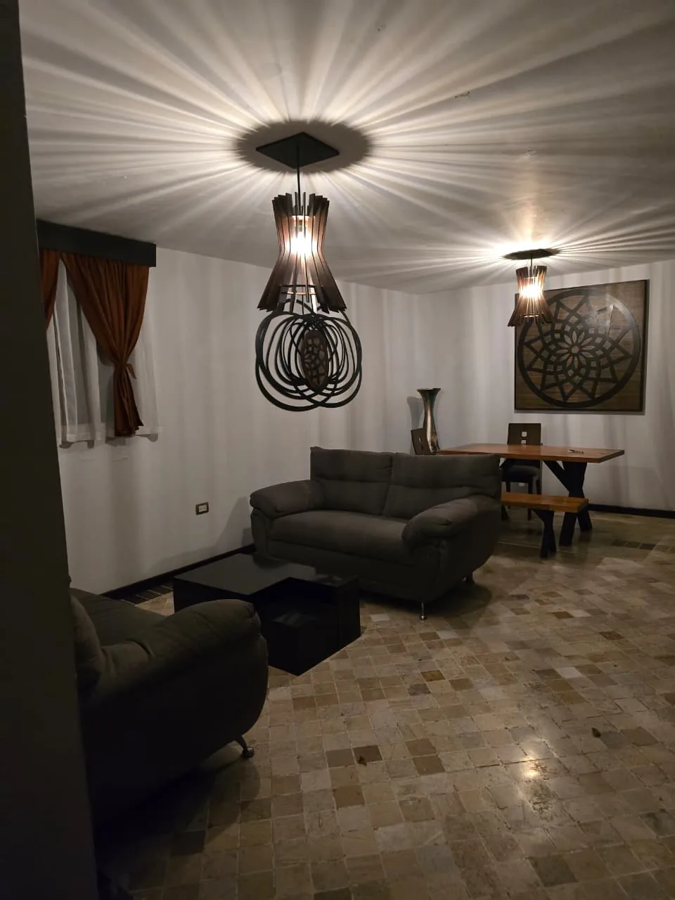 Sala interior del Hotel Godettia con muebles cálidos y lámparas de madera